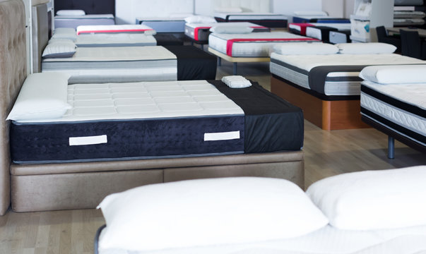 Image of new modern mattresses on the beds in the store