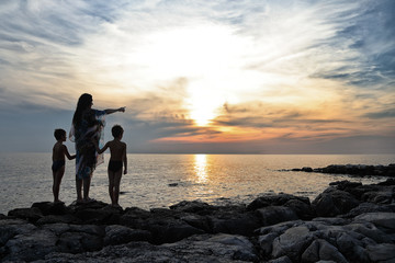 Family Vacation - Mother And Her Sons Enjoying Beautiful Sunset On Beach