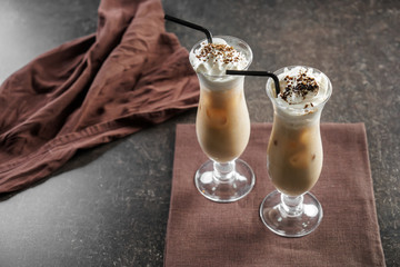 Glasses of cold frappe coffee on grey table