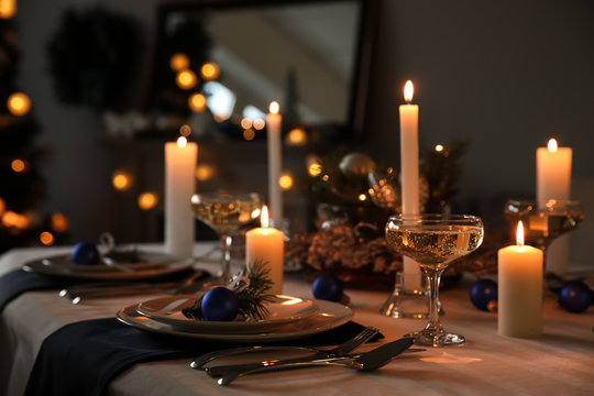Burning candles on beautiful  table setting for Christmas dinner