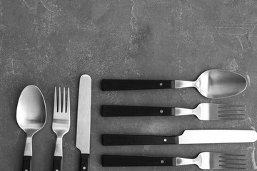 Set of cutlery on grey background, flat lay