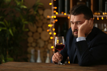 Man drinking wine in bar