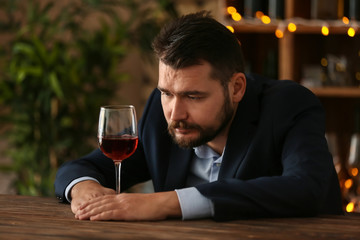 Man drinking wine in bar