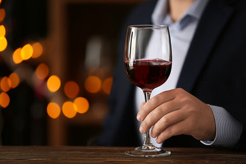 Man with glass of wine in bar