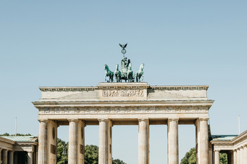 Closeup of the Brandenburg Gate against the blue sky. This is one of the attractions of Berlin in Germany.