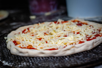 A raw pizza prepared to be cooked in the oven