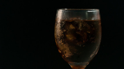 sparkling water with ice on black background.