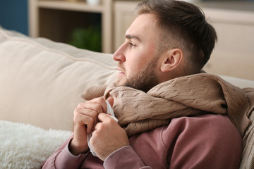 Young man ill with flu at home