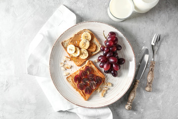 Plate with different delicious toasts on table
