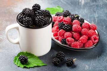 Cup of ripe blackberries and raspberries