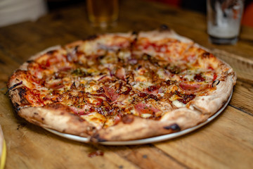 A closeup on a delicious meat pizza already sliced and ready to be eaten