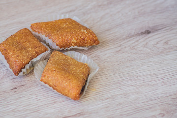 Honey bars made of sesame seeds. Orient delight on wooden table.