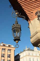 Fototapeta na wymiar city-scape of Krakow's Market Place and streetlamps