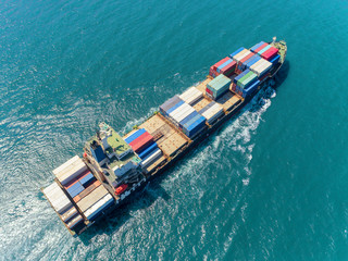 Aerial top view container ship at sea port  loading container for import export, shipping or...