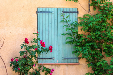 Fototapeta na wymiar Lurs France. 15 september 2018. Window with closed shutters and flowers at the village of Lurs in Provence France.