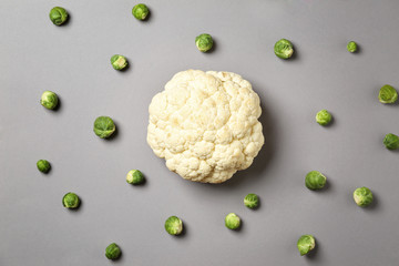 Fresh cauliflower and Brussels cabbage on grey background
