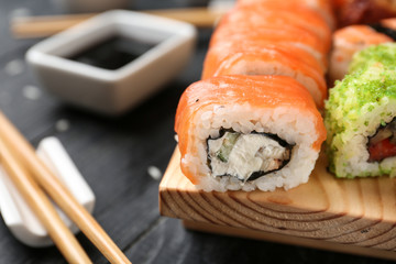 Tasty sushi on wooden stand, closeup