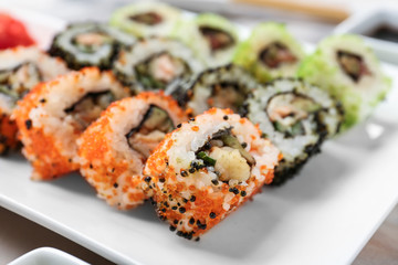 Set of tasty sushi on plate, closeup
