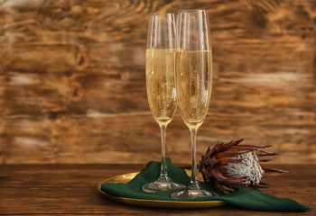 Glasses of champagne on wooden background