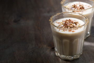 creamy cocktail with muesli on dark background