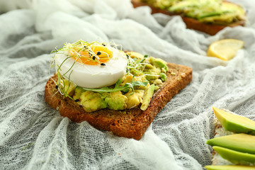 Delicious avocado toast on table