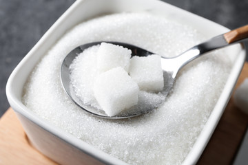 Bowl with sugar and spoon, closeup