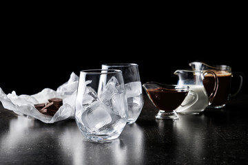 Ingredients for preparing cold coffee on dark table