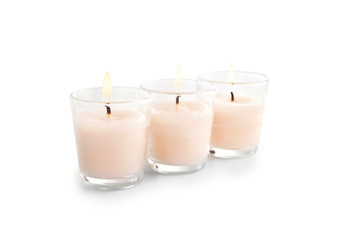 Burning candles on white background