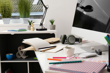 Stylish workplace of designer with modern computer
