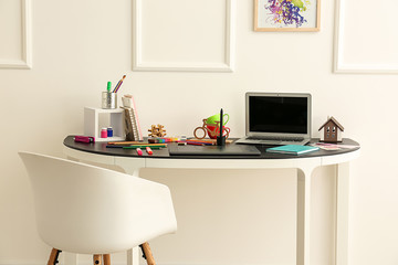 Stylish workplace of designer with modern laptop