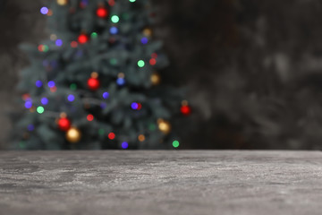 Grunge table against glowing Christmas tree