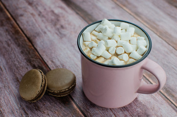 Cocoa drink with spices, zephyr on wooden background
