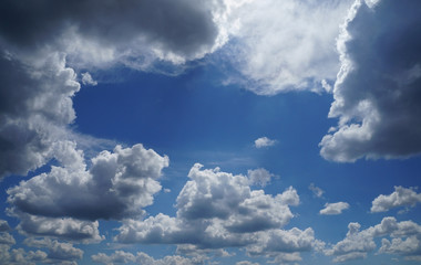 sky with white fluffy and rainy dark clouds after rain. Background texture.  