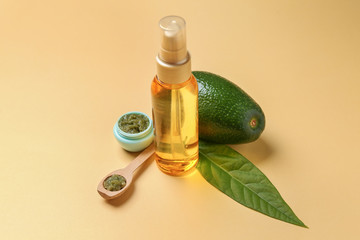 Composition with fresh avocado and natural cosmetics on color background