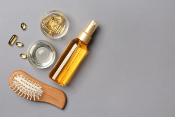 Flat lay composition with natural cosmetics for hair on grey background