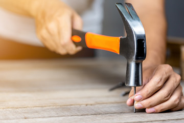 Carpenter man hammering a nail