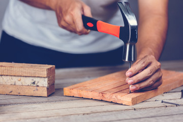 Carpenter man hammering a nail