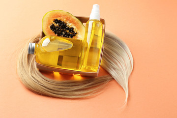 Composition with papaya and natural cosmetics for hair on color background