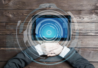 Business workplace with tablet device on wooden surface and media interface