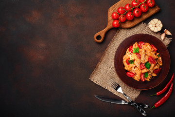 Pasta with cheese, cherry tomato sauce on rusty background.