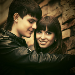 Happy young couple in love embracing on city street