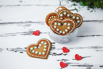 Gingerbread Cookies hearts in a cup on a white wooden background. Valentines day concept