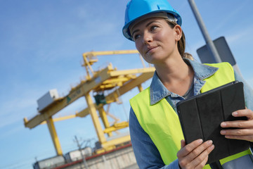 Woman on a building site checking looking out
