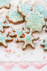 Obraz na płótnie Canvas Christmas decoration with cookies in the shape of snowflakes and stars on a white background. Top view.