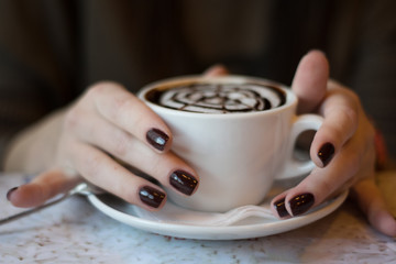 a cup of coffee, cappuccino, latte in beautiful female hands. coffee mood. Cheerful morning in a cafe. wallpaper