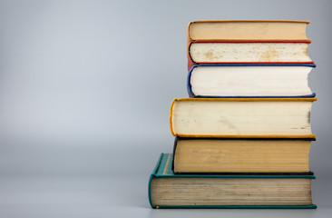 Stack of old books on gray background