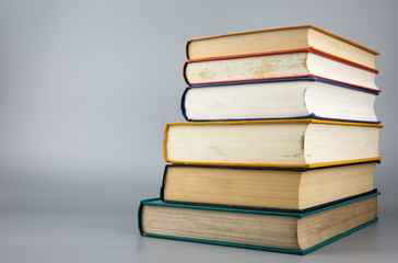 Stack of old books on gray background