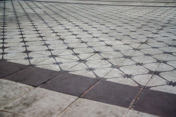 Old ceramic floor detail with colors brown and white with perspective