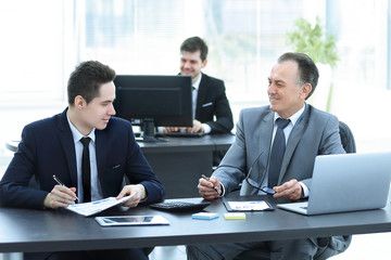 business colleagues sitting at a Desk in the office.