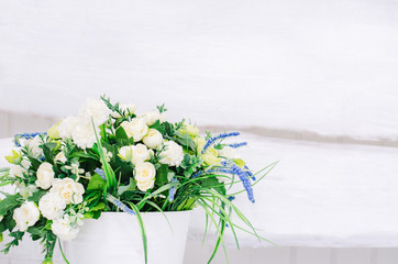 Pail with flowers on a white background.